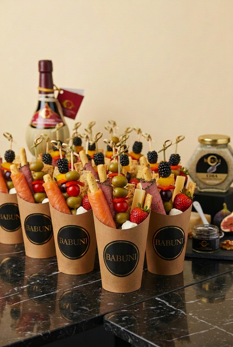 BABUNI cups with one smoked-salmon-wrapped breadstick and one Montreal smoked-meat-wrapped breadstick per cup